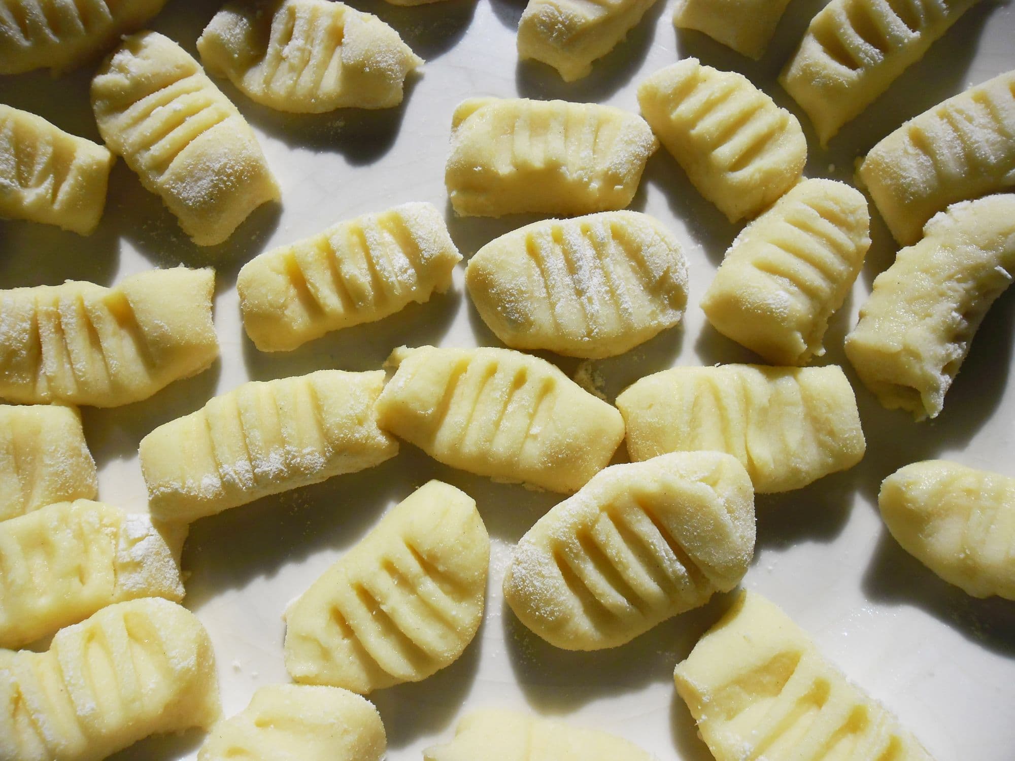 Raw potato gnocchi marked with fork ridges, lightly dusted with flour